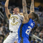 
              Indiana Pacers guard Tyrese Haliburton (0) shoots under pressure from Orlando Magic guard Markelle Fultz (20) during the first half of an NBA basketball game Saturday, Feb. 25, 2023, in Orlando, Fla. (AP Photo/Alan Youngblood)
            