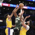
              Milwaukee Bucks forward Giannis Antetokounmpo, center, shoots as Los Angeles Lakers guard Max Christie, left, and forward Anthony Davis defend during the first half of an NBA basketball game Thursday, Feb. 9, 2023, in Los Angeles. (AP Photo/Mark J. Terrill)
            