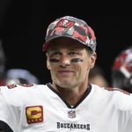 
              FILE - Tampa Bay Buccaneers quarterback Tom Brady (12) smiles during warmups before an NFL football game, Sunday, Jan. 8, 2023, in Atlanta.  Brady, who won a record seven Super Bowls for New England and Tampa, has announced his retirement, Wednesday, Feb. 1, 2023. 
 (AP Photo/Hakim Wright Sr., File)
            