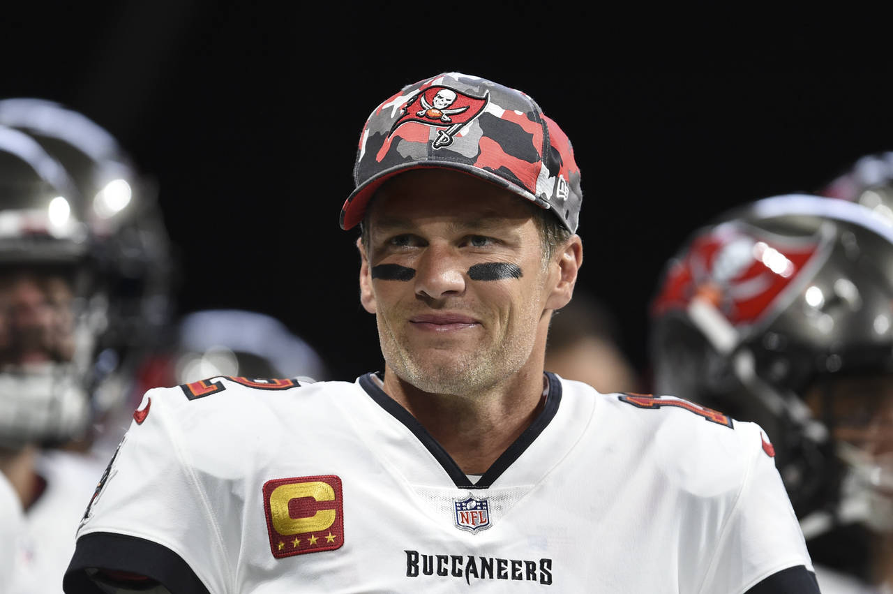 FILE - Tampa Bay Buccaneers quarterback Tom Brady (12) smiles during warmups before an NFL football...