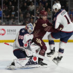 
              Columbus Blue Jackets goaltender Elvis Merzlikins makes a save in front of center Lane Pederson (18) and Arizona Coyotes center Barrett Hayton (29) during the first period during an NHL hockey game Sunday, Feb. 19, 2023, in Tempe, Ariz. (AP Photo/Rick Scuteri)
            