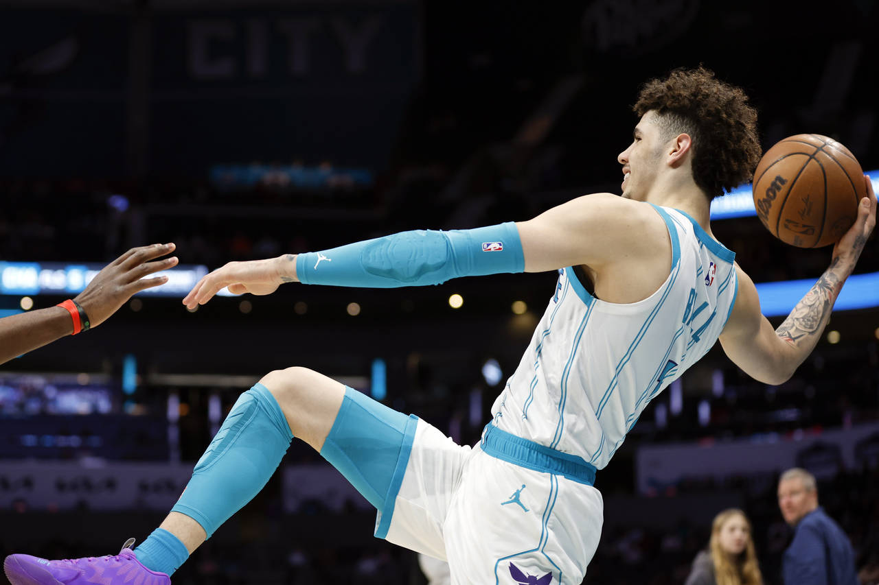 Charlotte Hornets guard LaMelo Ball passes the ball as he tries to stay inbound during the first ha...
