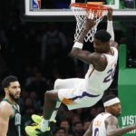 
              Phoenix Suns' Deandre Ayton (22) dunks in front of Boston Celtics' Jayson Tatum (0) during the first half of an NBA basketball game, Friday, Feb. 3, 2023, in Boston. (AP Photo/Michael Dwyer)
            