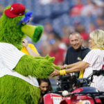 
              FILE - First lady Jill Biden greets the Phillie Phanatic mascot after participating in the Philadelphia Phillies' sixth annual "Childhood Cancer Awareness Night" before a baseball game against the Washington Nationals, Sept. 9, 2022, in Philadelphia. (AP Photo/Matt Slocum, File)
            