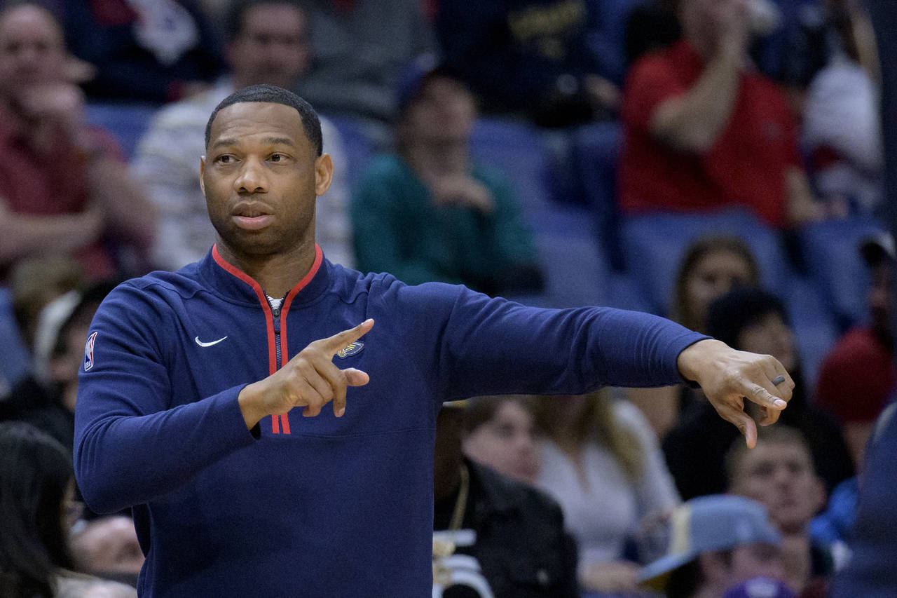 New Orleans Pelicans head coach Willie Green signals in the first half of an NBA basketball game ag...