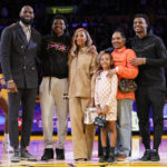 
              Los Angeles Lakers forward LeBron James , left, poses for a photo with his family during a ceremony honoring him as the NBA's all-time leading scorer before an NBA game against the Milwaukee Bucks on Thursday, Feb. 9, 2023, in Los Angeles. James passed Kareem Abdul-Jabbar to earn the record during Tuesday's NBA game against the Oklahoma City Thunder. From left, LeBron James, (AP Photo/Mark J. Terrill)
            