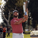 
              Jon Rahm hold the winner's trophy after winning the Genesis Invitational golf tournament at Riviera Country Club, Sunday, Feb. 19, 2023, in the Pacific Palisades area of Los Angeles. (AP Photo/Ryan Kang)
            
