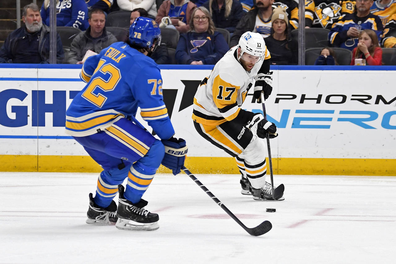 Pittsburgh Penguins right wing Bryan Rust (17) controls the puck as St. Louis Blues defenseman Just...