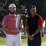 
              Jon Rahm, left, holds the winner's trophy next to Tiger Woods after winning the Genesis Invitational golf tournament at Riviera Country Club, Sunday, Feb. 19, 2023, in the Pacific Palisades area of Los Angeles. (AP Photo/Ryan Kang)
            