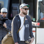 
              Kansas City Chiefs tight end Travis Kelce, center, walks to a bus after he and teammates returned home a day after winning the NFL Super Bowl 57 football game, Monday, Feb. 13, 2023, in Kansas City, Mo. (AP Photo/Colin E. Braley)
            