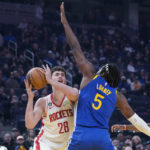 
              Houston Rockets center Alperen Sengun, left, tries to shoot while defended by Golden State Warriors center Kevon Looney during the first half of an NBA basketball game in San Francisco, Friday, Feb. 24, 2023. (AP Photo/Godofredo A. Vásquez)
            