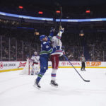
              Vancouver Canucks' Elias Pettersson, left, and New York Rangers' Braden Schneider jump for the puck during the third period of an NHL hockey game Wednesday, Feb. 15, 2023, in Vancouver, British Columbia. (Darryl Dyck/The Canadian Press via AP
            