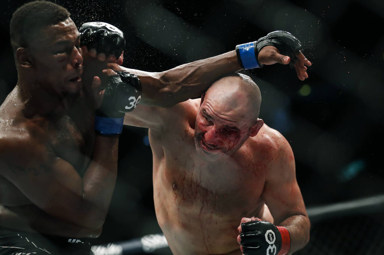Jamahal Hill, left, of the U.S., competes with Brazil's Glover Teixeira in a light heavyweight titl...