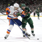 
              New York Islanders left wing Anders Lee, left, and Minnesota Wild defenseman Jared Spurgeon battle for the puck during the second period of an NHL hockey game Tuesday, Feb. 28, 2023, in St. Paul, Minn. (AP Photo/Abbie Parr)
            