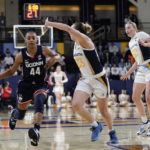 
              UConn's Aubrey Griffin (44) drives to the basket against Marquette's Jordan King (23) and Chloe Marotta (52) during the first half of an NCAA college basketball game Wednesday, Feb. 8, 2023, in Milwaukee. (AP Photo/Aaron Gash)
            