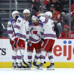 
              New York Rangers center Vincent Trocheck (16) celebrates with right wing Kaapo Kakko (24), defenseman K'Andre Miller (79) and left wing Alexis Lafrenière, right, after scoring against the Detroit Red Wings during the second period of an NHL hockey game Thursday, Feb. 23, 2023, in Detroit. (AP Photo/Duane Burleson)
            