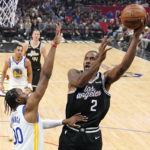 
              Los Angeles Clippers forward Kawhi Leonard, right, shoots as Golden State Warriors forward Jonathan Kuminga defends during the first half of an NBA basketball game Tuesday, Feb. 14, 2023, in Los Angeles. (AP Photo/Mark J. Terrill)
            