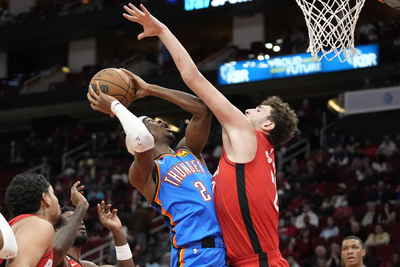 Oklahoma City Thunder guard Shai Gilgeous-Alexander (2) shoots as Houston Rockets center Alperen Se...