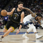 
              Golden State Warriors guard Klay Thompson (11) works towards the basket while defended by Minnesota Timberwolves guard D'Angelo Russell (0) during the second half of an NBA basketball game, Wednesday, Feb. 1, 2023, in Minneapolis. (AP Photo/Abbie Parr)
            