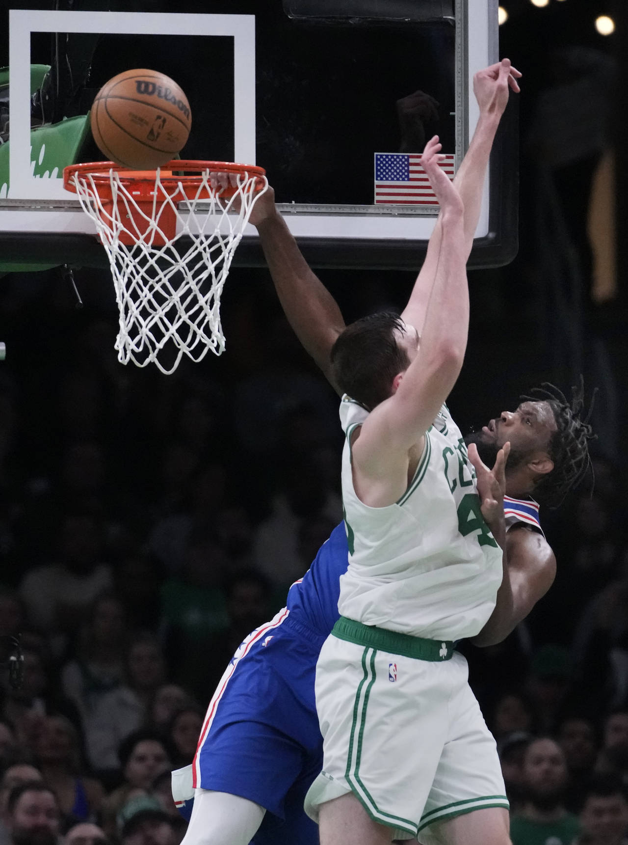 Philadelphia 76ers center Joel Embiid, rear, is blocked on a dunk attempt against Boston Celtics ce...