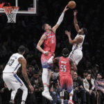 
              Washington Wizards center Kristaps Porzingis, second from left, attempts to block Brooklyn Nets guard Cam Thomas, during the second half of an NBA basketball game, Saturday, Feb. 4, 2023, in New York. (AP Photo/Bebeto Matthews)
            