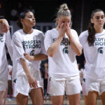 
              Michigan State players including Stephanie Visscher, from left, Moira Joiner, Theryn Hallock and Abbey Kimball stand together before an NCAA college basketball game against Maryland, Saturday, Feb. 18, 2023, in East Lansing, Mich. (AP Photo/Al Goldis)
            