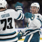 
              San Jose Sharks defenseman Scott Harrington (4) celebrates his goal against the Tampa Bay Lightning with center Noah Gregor (73) during the third period of an NHL hockey game Tuesday, Feb. 7, 2023, in Tampa, Fla. (AP Photo/Chris O'Meara)
            