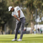 
              Tiger Woods hits his second shot on the 11th hole during the third round of the Genesis Invitational golf tournament at Riviera Country Club, Saturday, Feb. 18, 2023, in the Pacific Palisades area of Los Angeles. (AP Photo/Ryan Kang)
            