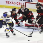 
              St. Louis Blues' Sammy Blais (79) and Ottawa Senators' Artem Zub (2) and Tim Stutzle (18) eye the puck in front of Senators goaltender Mads Sogaard (40) during the first period of an NHL hockey game Sunday, Feb. 19, 2023, in Ottawa, Ontario. (Patrick Doyle/The Canadian Press via AP)
            