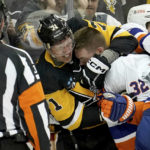 
              Pittsburgh Penguins center Evgeni Malkin (71) fights New York Islanders left wing Ross Johnston (32) during the second period of an NHL hockey game in Pittsburgh, Monday, Feb. 20, 2023. (AP Photo/Matt Freed)
            