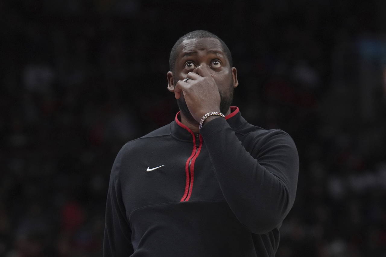 Toronto Raptors assistant coach Adrian Griffin reacts during an NBA basketball game against the Det...