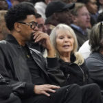 
              Shelly Sterling, center, sits with Jalen Rose, left, during the first half of an NBA basketball game between the Los Angeles Clippers and the Dallas Mavericks Wednesday, Feb. 8, 2023, in Los Angeles. (AP Photo/Mark J. Terrill)
            