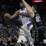 
              Philadelphia 76ers center Joel Embiid (21) drives to the basket against San Antonio Spurs forward Zach Collins (23) during the first half of an NBA basketball game in San Antonio, Friday, Feb. 3, 2023. (AP Photo/Eric Gay)
            