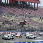 
              NASCAR Xfinity Series drivers pass the start-finish line at Auto Club Speedway as track dryers are used on the damp surface Saturday, Feb. 25, 2023, in Fontana, Calif. The race was stopped after just two pace laps due to persistent rain. The race was postponed. (Will Lester/The Orange County Register via AP)
            