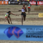 
              Letesenbet Gidey of Ethiopia, left, falls as Beatrice Chebet of Kenya passes her to win the senior women's race at the World Athletics Cross Country Championships in Bathurst, Australia, Saturday, Feb. 18, 2023. (Dean Lewins/AAP Image via AP)
            