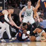 
              Boston Celtics forward Grant Williams, right, and New York Knicks guard RJ Barrett (9) scramble for a loose ball during the first half of an NBA basketball game, Monday, Feb. 27, 2023, in New York. (AP Photo/John Minchillo)
            