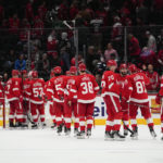 
              Detroit Red Wings players celebrate after defeating the Washington Capitals 3-1 during an NHL hockey game, Tuesday, Feb. 21, 2023, in Washington. (AP Photo/Julio Cortez)
            