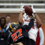 
              National receiver Michael Wilson of Stanford (4) catches a pass over cornerback Riley Moss of Iowa (27) during practice for the Senior Bowl NCAA college football game Wednesday, Feb. 1, 2023, in Mobile, Ala.. (AP Photo/Butch Dill)
            