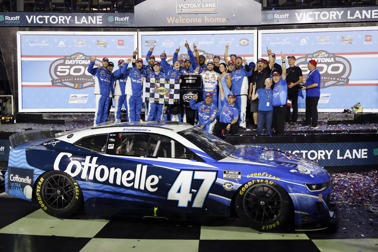 Ricky Stenhouse Jr., center and his wife Madyson Joye Goodfleisch celebrate in Victory Lane with hi...