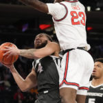 
              St. John's forward David Jones (23) defends as Providence guard Jared Bynum (4) drives to the basket during the first half of an NCAA college basketball game, Saturday, Feb. 11, 2023 in New York. (AP Photo/Bryan Woolston)
            