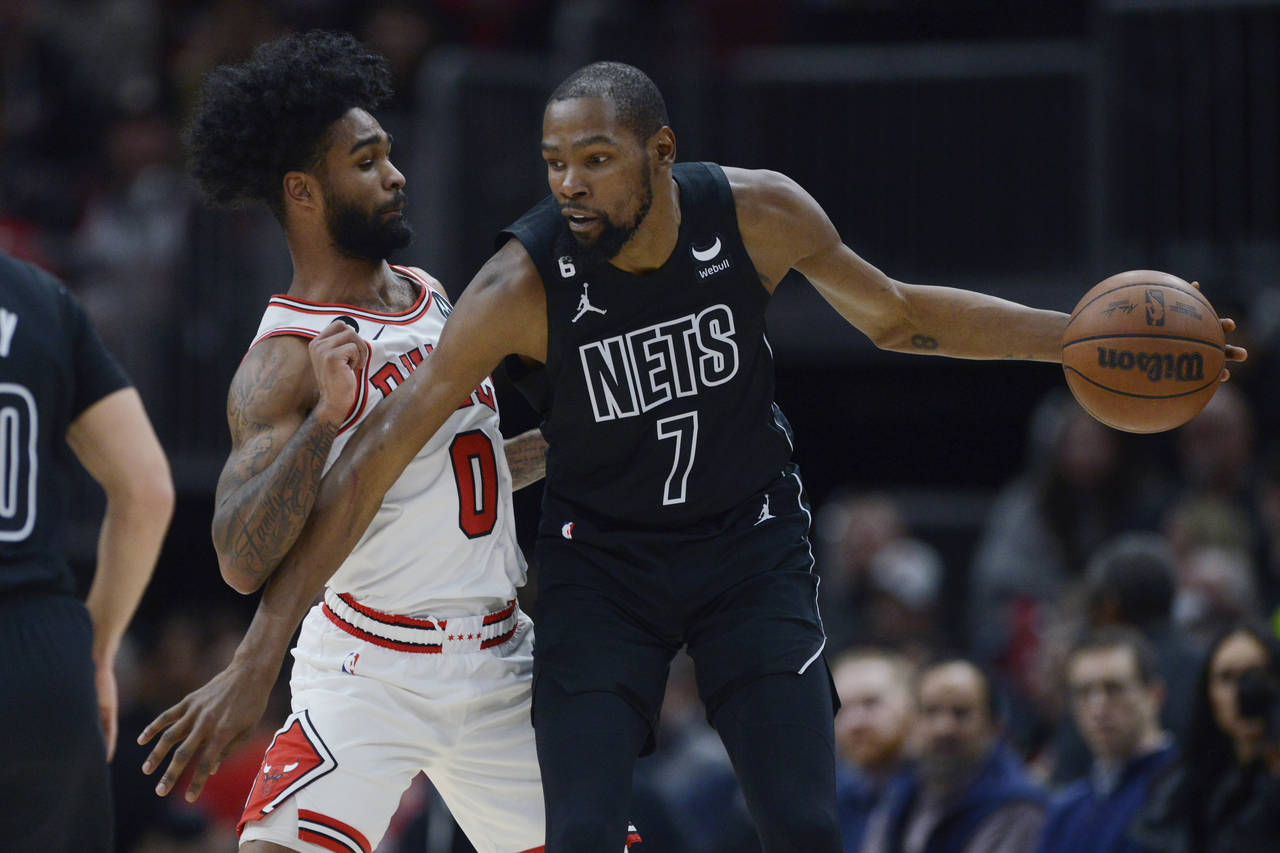 FILE - Brooklyn Nets' Kevin Durant (7) looks to drive against Chicago Bulls' Coby White (0) during ...