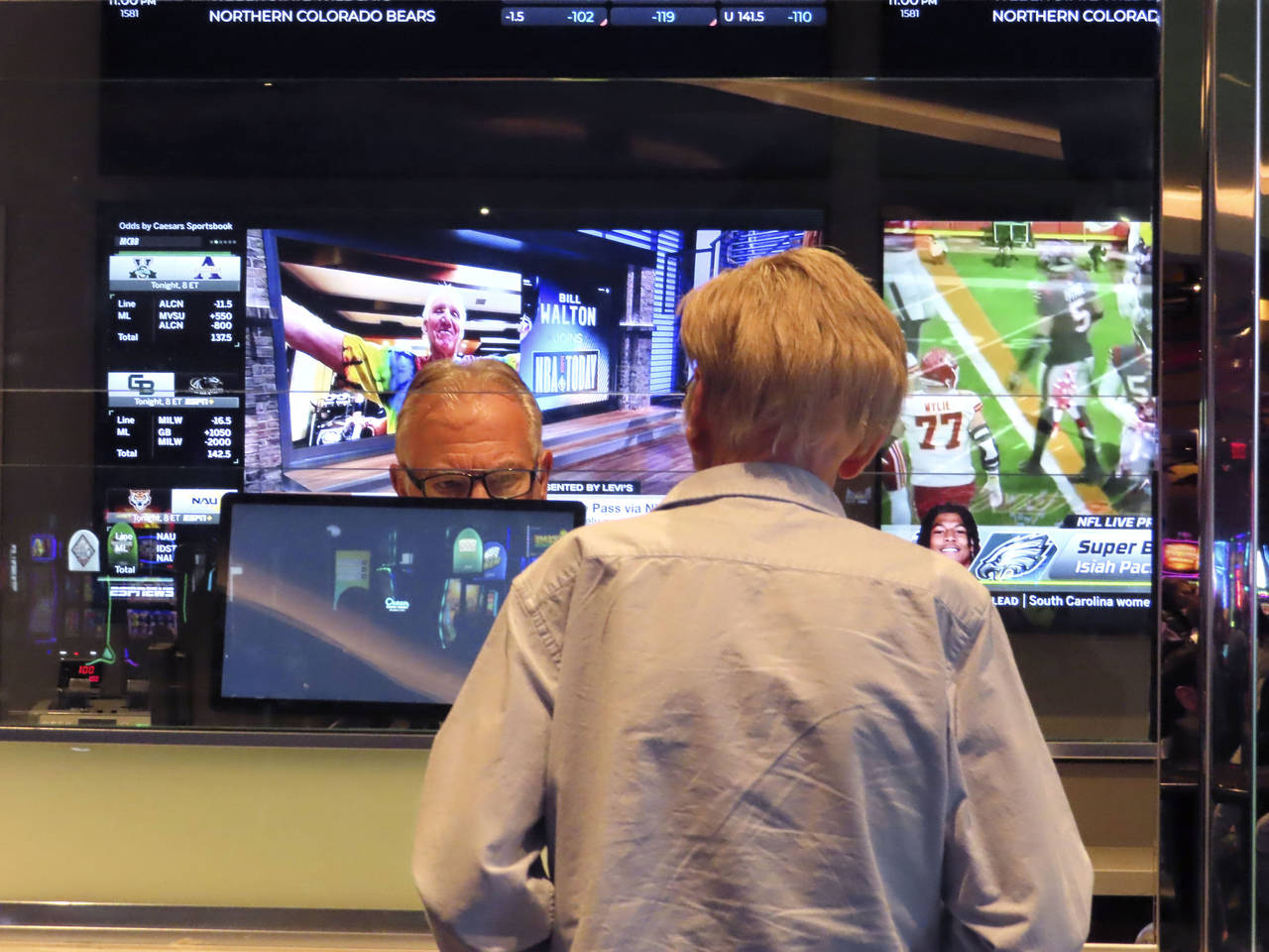 A customer, right, makes a sports bet at the Ocean Casino Resort in Atlantic City, N.J., Monday, Fe...