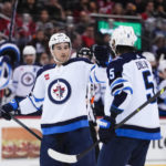 
              Winnipeg Jets' Neal Pionk, center, celebrates with teammates after scoring a goal against the New Jersey Devils during the first period of an NHL hockey game Sunday, Feb. 19, 2023, in Newark, N.J. (AP Photo/Frank Franklin II)
            