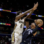 
              Orlando Magic forward Paolo Banchero (5) shoots as New Orleans Pelicans forward Naji Marshall (8) defends in the second half of an NBA basketball game in New Orleans, Monday, Feb. 27, 2023. (AP Photo/Derick Hingle)
            