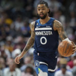 
              Minnesota Timberwolves guard D'Angelo Russell brings the ball up the court against the Denver Nuggets in the first half of an NBA basketball game Tuesday, Feb. 7, 2023, in Denver. (AP Photo/David Zalubowski)
            