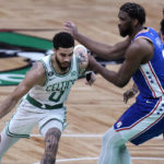 
              Boston Celtics forward Jayson Tatum (0) drives to the basket against Philadelphia 76ers center Joel Embiid during the first half of an NBA basketball game, Wednesday, Feb. 8, 2023, in Boston. At rear right is Philadelphia 76ers guard James Harden (1). (AP Photo/Charles Krupa)
            