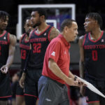 
              Houston coach Kelvin Sampson, front, walks off the court past Tramon Mark (12), J'Wan Roberts (13), Reggie Chaney (32) and Marcus Sasser (0) after drawing up a play late in the second half of the team's NCAA college basketball game against SMU, Thursday, Feb. 16, 2023, in Dallas. (AP Photo/Tony Gutierrez)
            