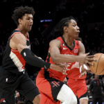 
              Portland Trail Blazers forward Matisse Thybulle, left, pokes the ball away from Houston Rockets guard TyTy Washington Jr., right, during the first half of an NBA basketball game in Portland, Ore., Sunday, Feb. 26, 2023. (AP Photo/Steve Dykes)
            