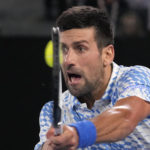 
              FILE - Novak Djokovic of Serbia plays a backhand return to Andrey Rublev of Russia during their quarterfinal match at the Australian Open tennis championship in Melbourne, Australia, Wednesday, Jan. 25, 2023. Djokovic broke the record for the most time spent at No. 1 in the professional tennis rankings by a man or woman, beginning his 378th week in the ATP’s top spot on Monday, Feb. 27, 2023, to surpass Steffi Graf’s 377 leading the WTA. (AP Photo/Dita Alangkara)
            