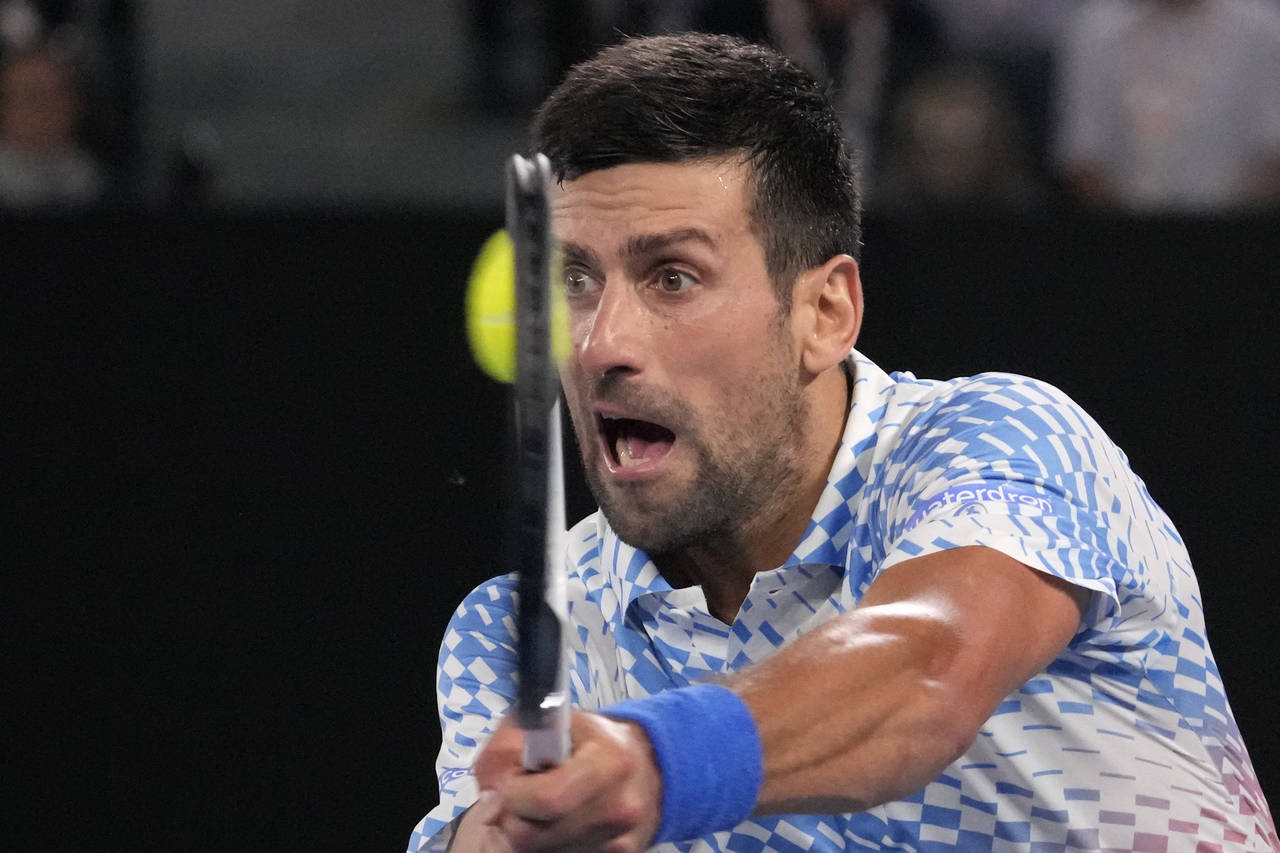 FILE - Novak Djokovic of Serbia plays a backhand return to Andrey Rublev of Russia during their qua...
